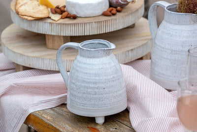 Our best-selling Alchemy footed pitcher: a timeless stoneware serveware with cute little feet and a unique bespeckled reactive glaze. Perfect for entertaining or displaying a fresh bouquet.