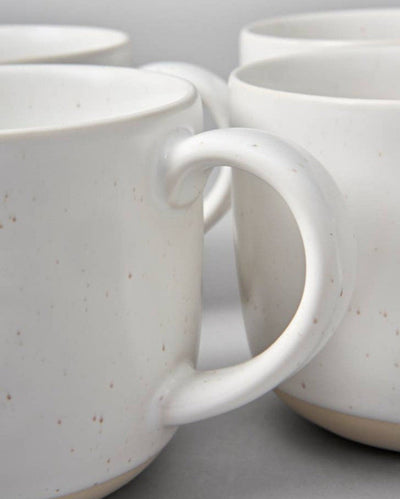 Closeup of stoneware mug handles in speckled white. Fable crockery.