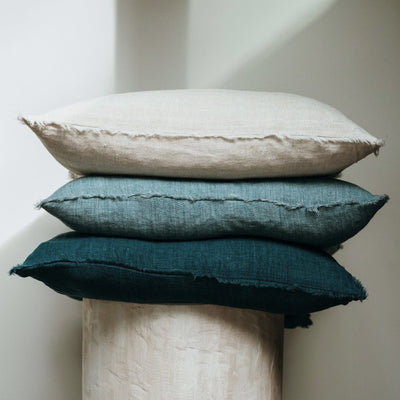 Indaba 1-3359-C - 24x24 arctic blue Lina Linen Pillow layered with 2 other pillows