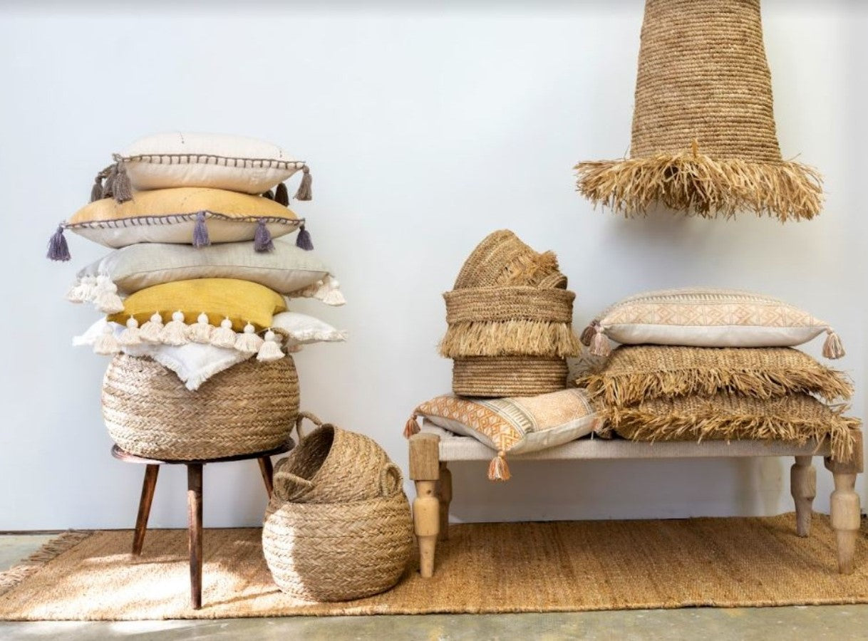 Indaba Lampshade - Rumbai Raffia hanging over bench with pillows