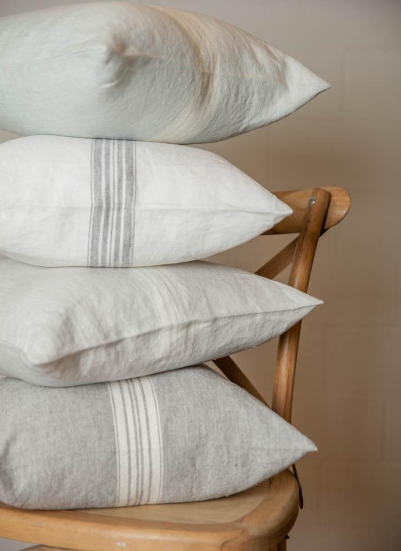 Maison Linen Pillows: By LinenWay. 18"x18" with down alternative insert.  Different colored pillows with stripes stacked on chair.
