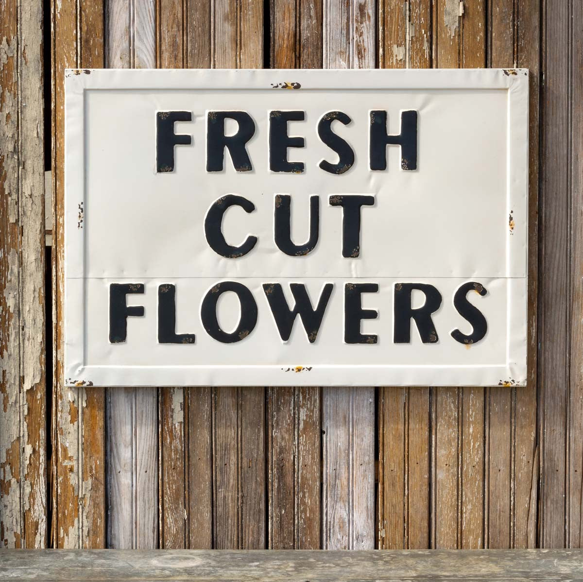 Metal Fresh Cut Flowers Sign: #EWA80544, 28x20 inches sign hung on rustic wooden wall.