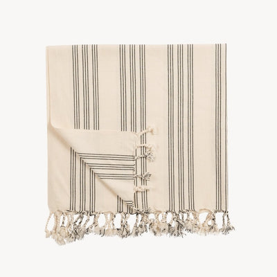 folded Pokoloko Aldo large Turkish cotton towel with tassels