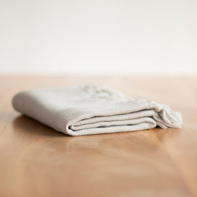 Turkish Hand Towel: Folded on table. Color in Haven · Size 41" x 23" · Brand - by House of Jude