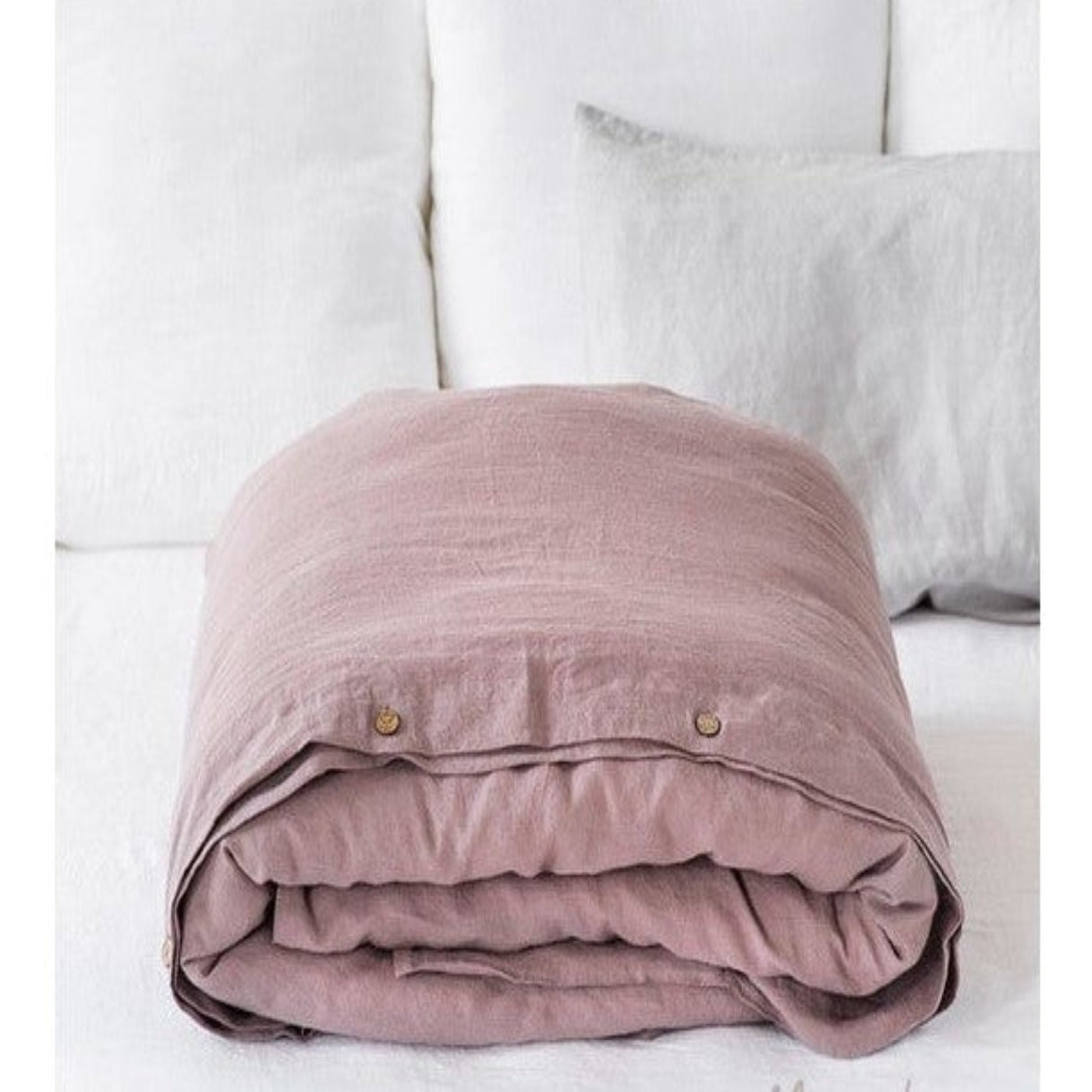 Woodrose Linen Duvet Cover: Folded on bed. Made from 100% European flax, in Lithuania.