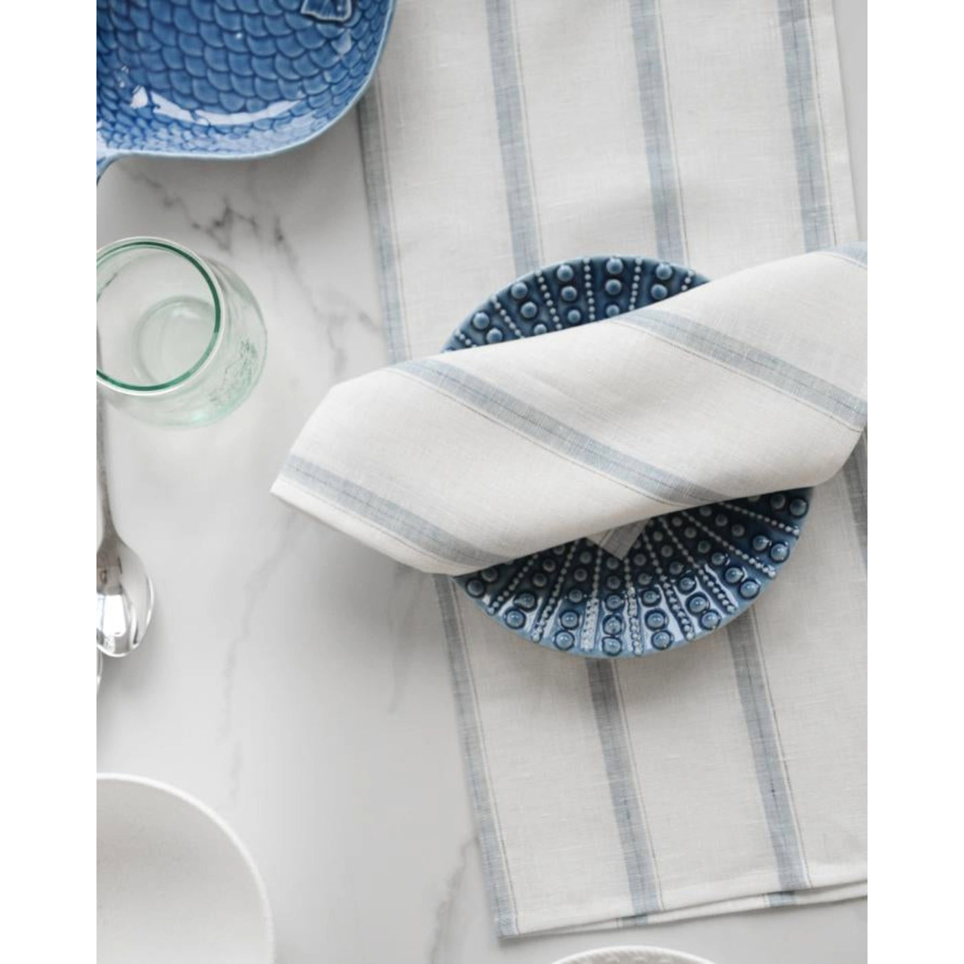 Hugo Linen Napkin: 18x18, folded on plate at table setting. Made from the finest European linen.- At Avalon Willow Home.