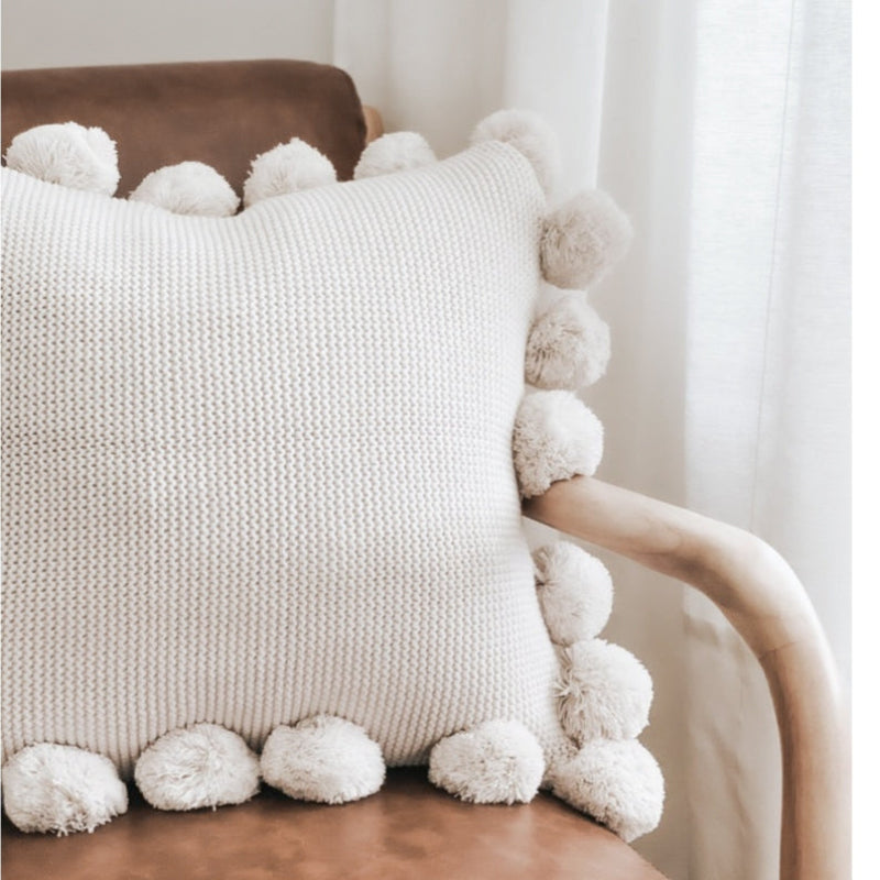 Knit pillow with poms