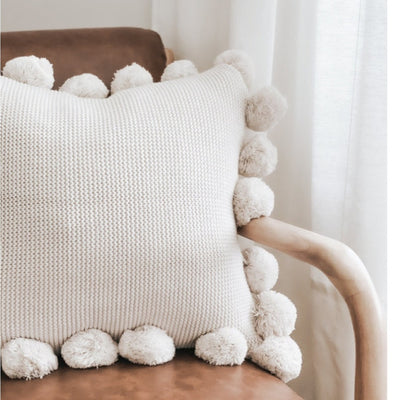 Knit pillow with poms