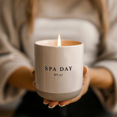 Spa Day Soy Candle: Woman holding stoneware candle while lit.