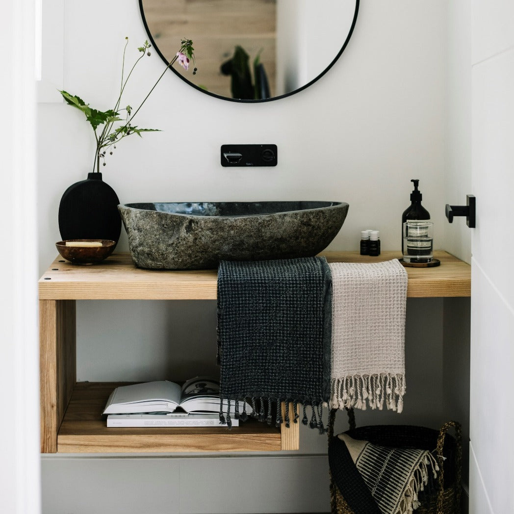 Stonewashed Clay Waffle Hand Towel hung on bathroom counter