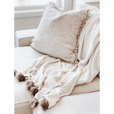 Faux Fur Poms Throw Blanket on couch with pillow