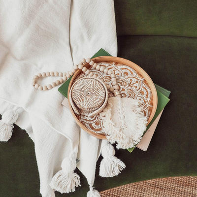 POKOLOKO DECOR Feather Beaded Tassel on couch and blanket.