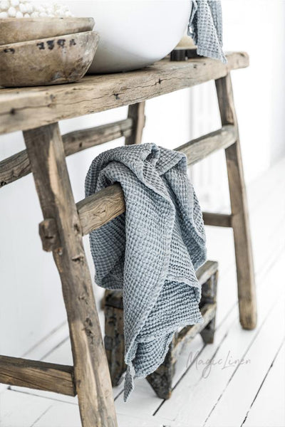 Waffle Towels Set of 3 - Light Grey Blue draped on wooden shelf.