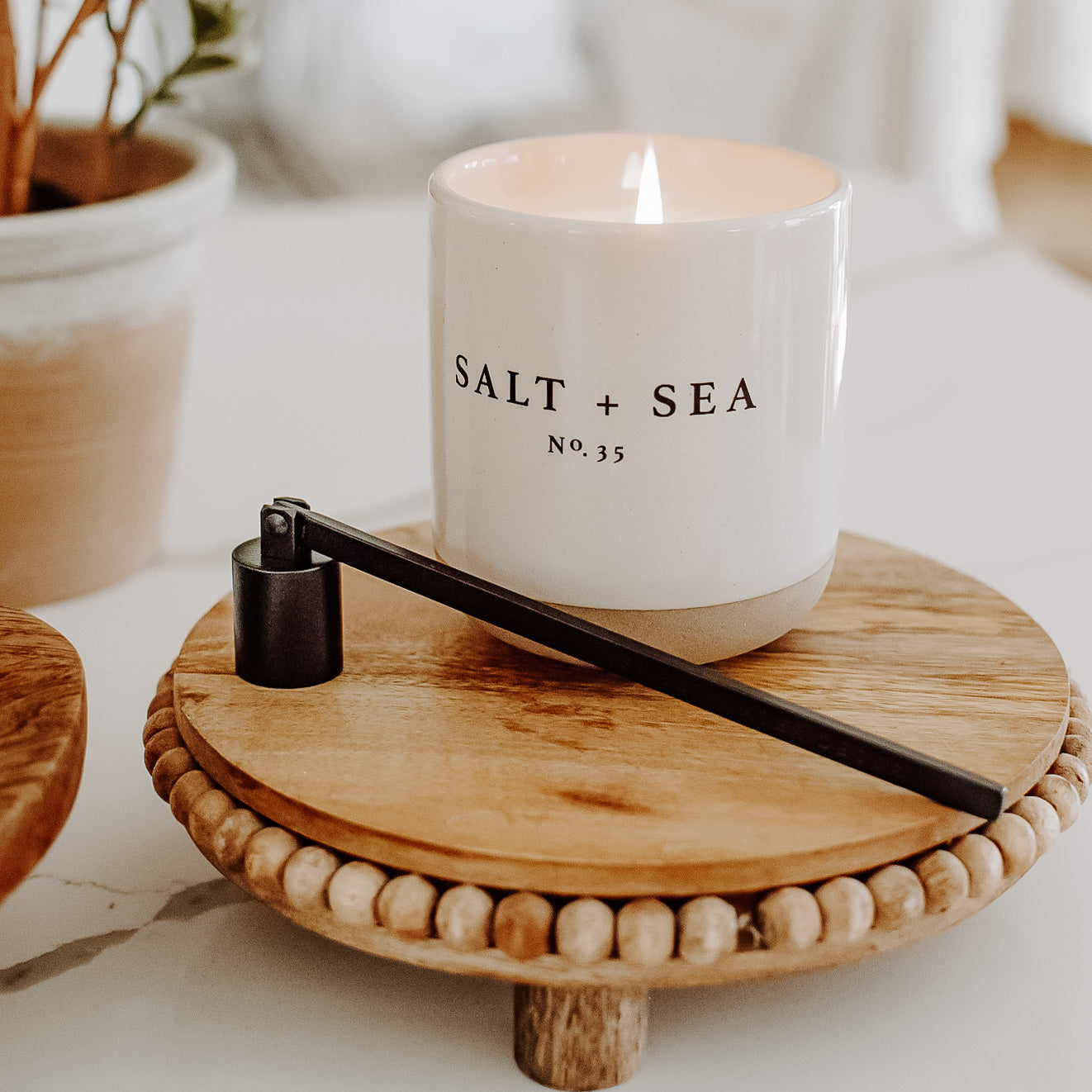 Sweet Water Decor Non-Toxic Candle - Salt & Sea scent - Stoneware Jar on beaded tray with black candle Snuffer