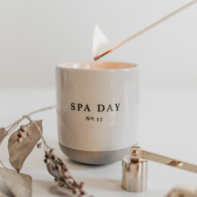 Spa Day Stoneware Soy Candle being lit with a long match.